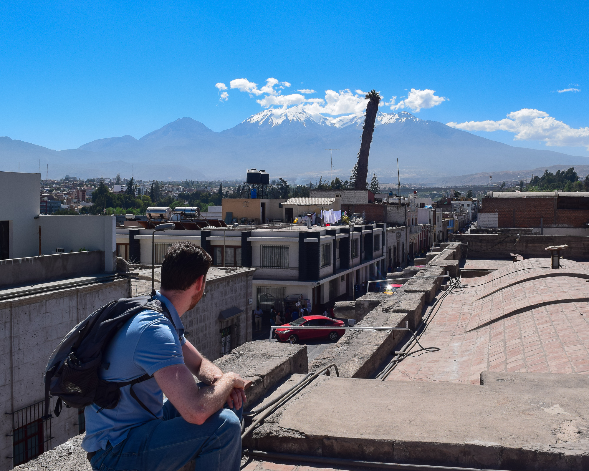 A man beside a tree against mountain backdrop, Arequipa — spiritual, pondering, solitary