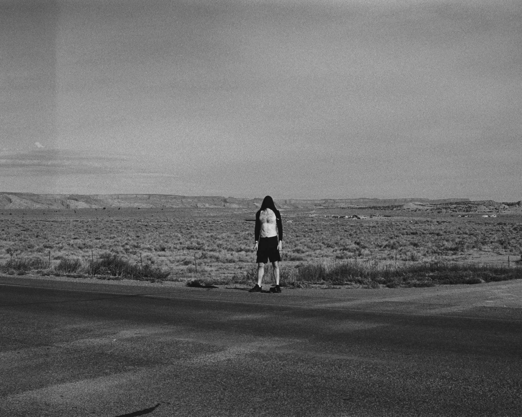 A portrait in Albuquerque with a retro atmosphere — color 35mm film, warm tones, the Southwest rendered in analog grain