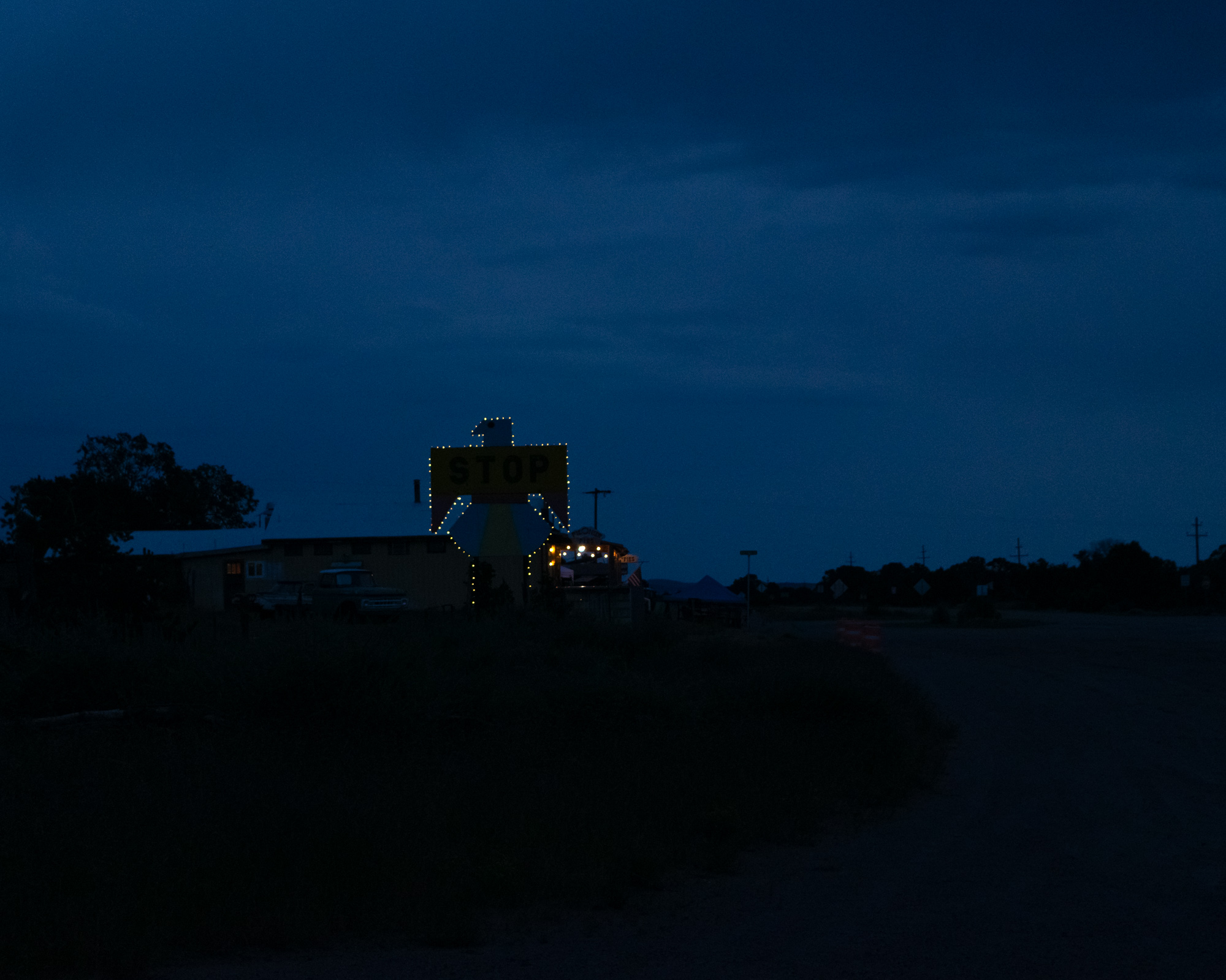 City lights spread across the Arizona desert at night, seen from an elevated vantage point against a deep dark sky