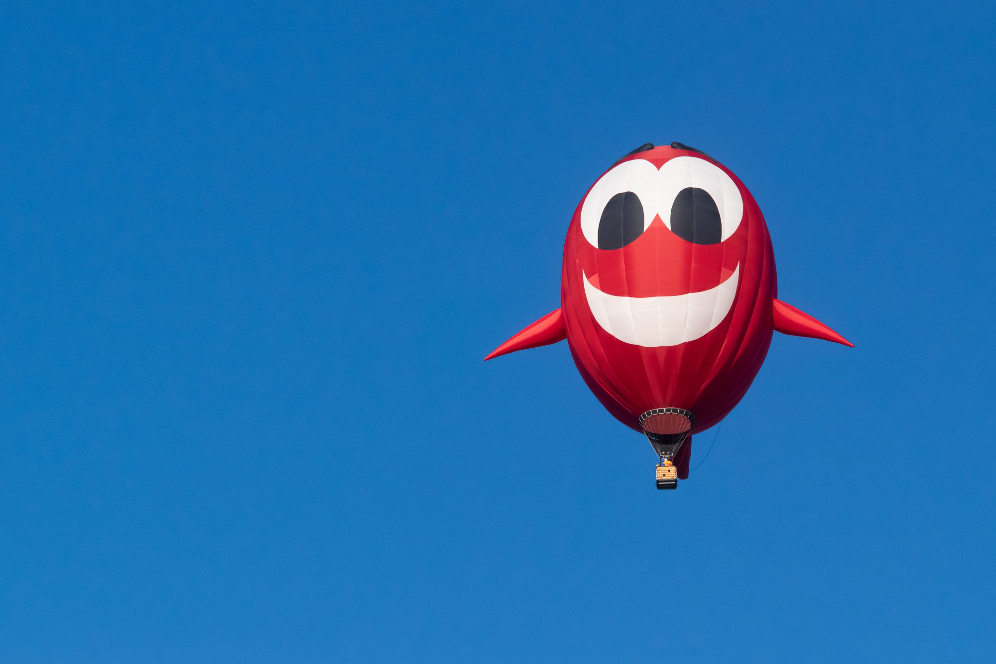 Multiple hot air balloons drift across a brilliant Colorado blue sky — the Southwest trip at its most open and unrestricted