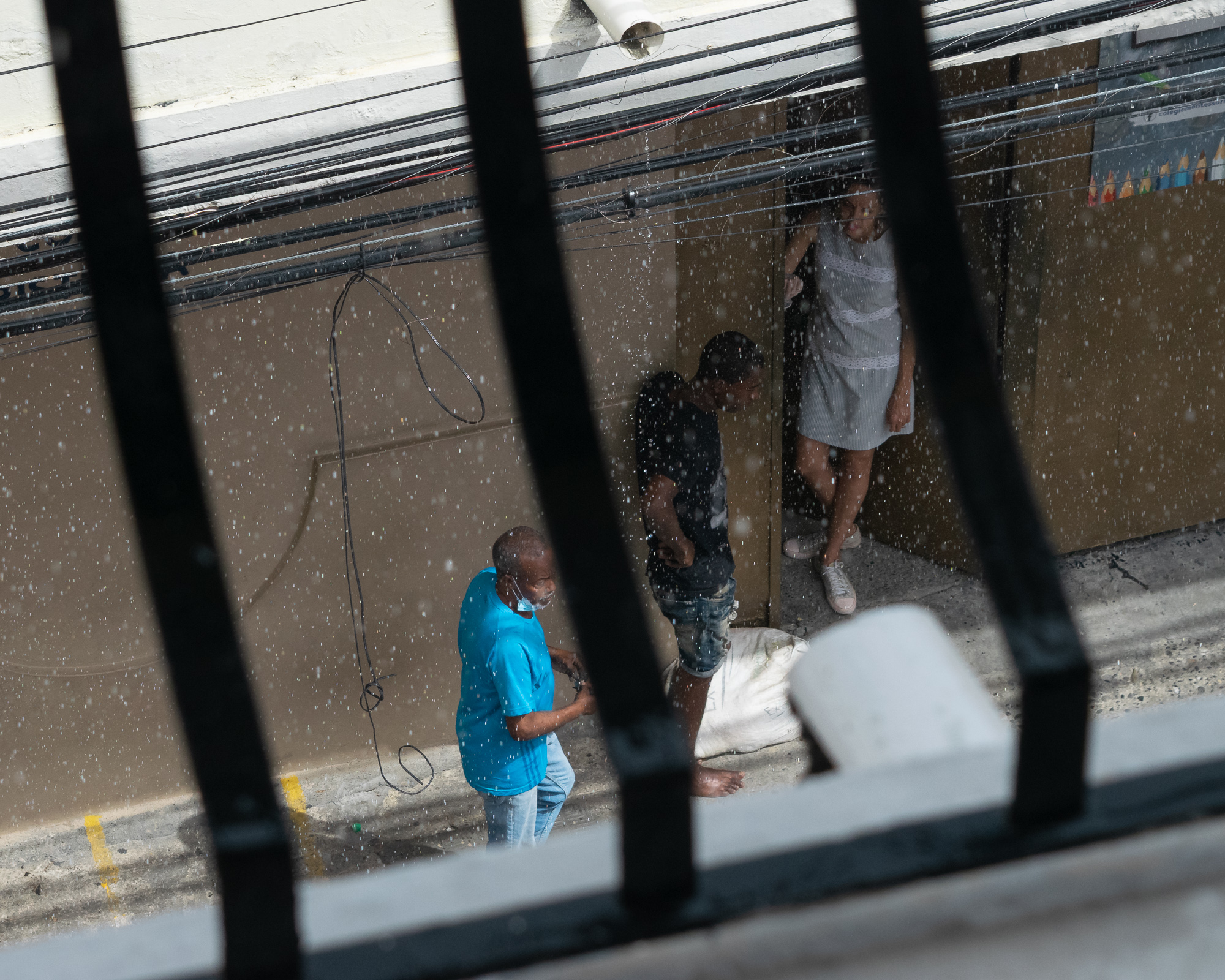 A candid geometric moment in the rain in Santo Domingo — atmospheric, abstract