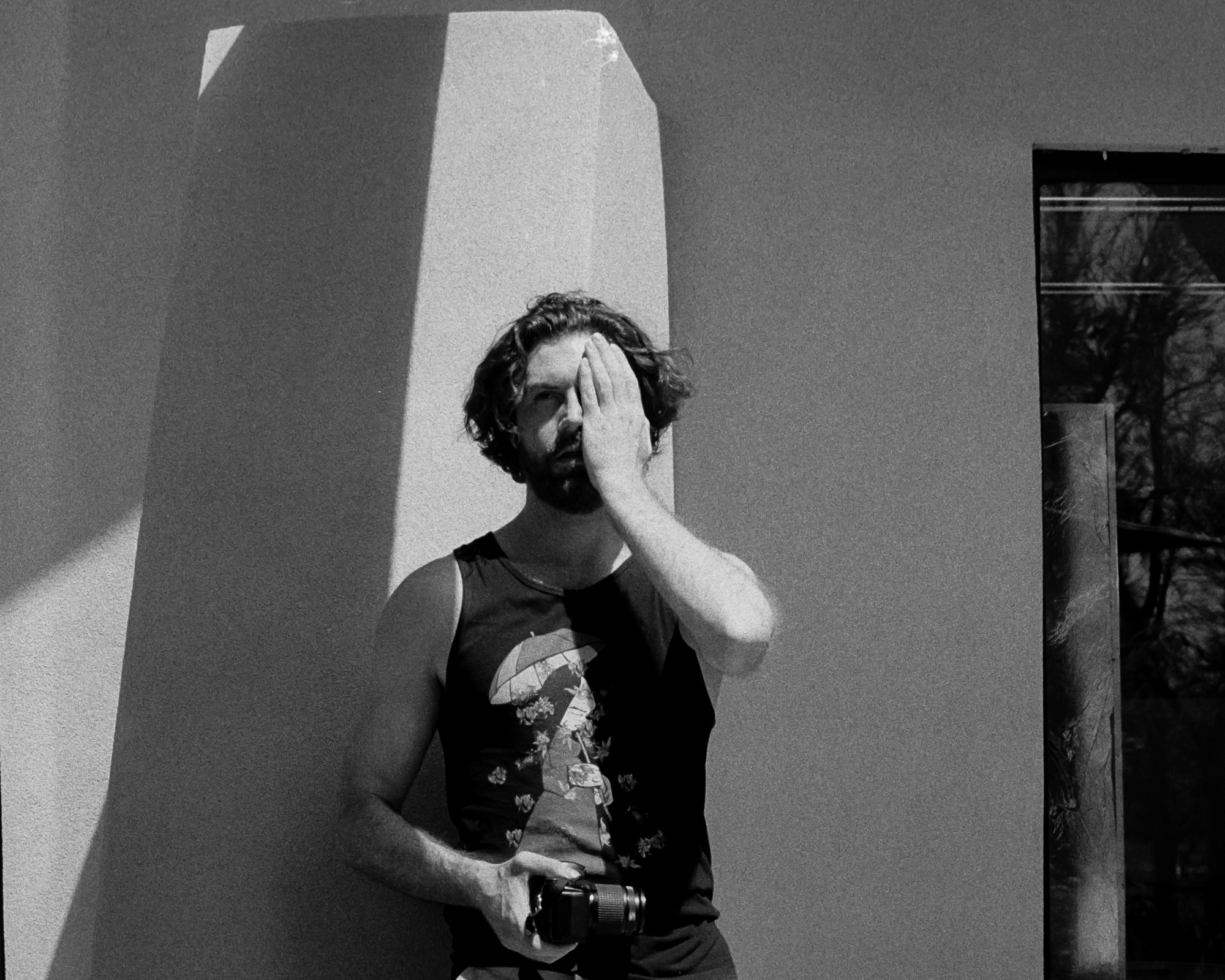 Portrait in strong Santa Fe light and shadow — hard contrast, analog black and white 35mm film