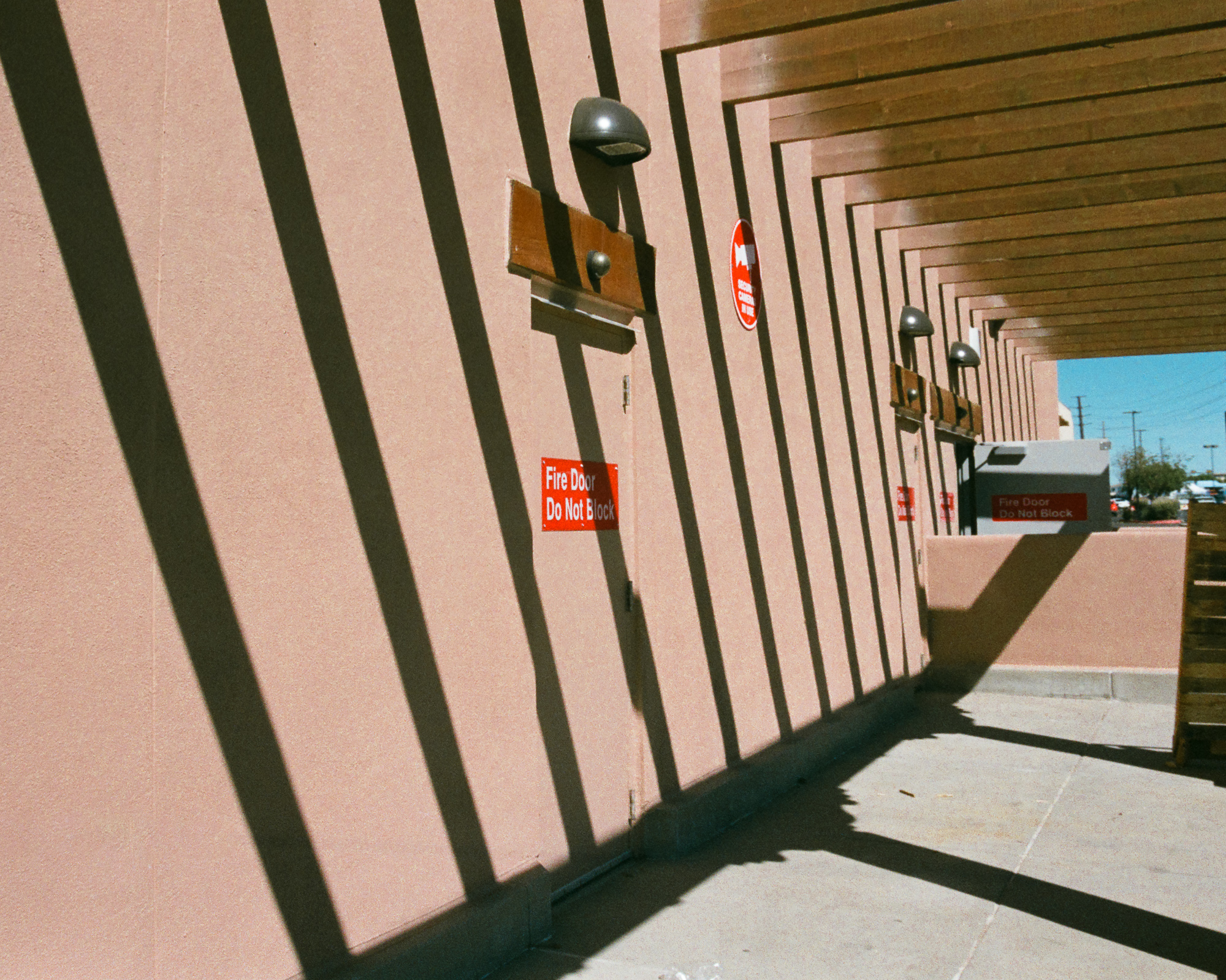 Light and shadow revealing warm color detail on an adobe wall in Santa Fe — color 35mm film