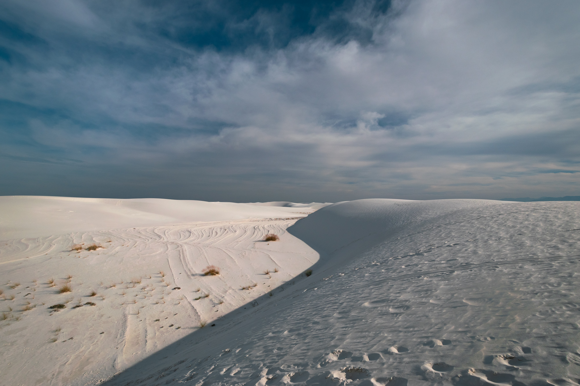 White Sands dunes under a cloud-streaked sky