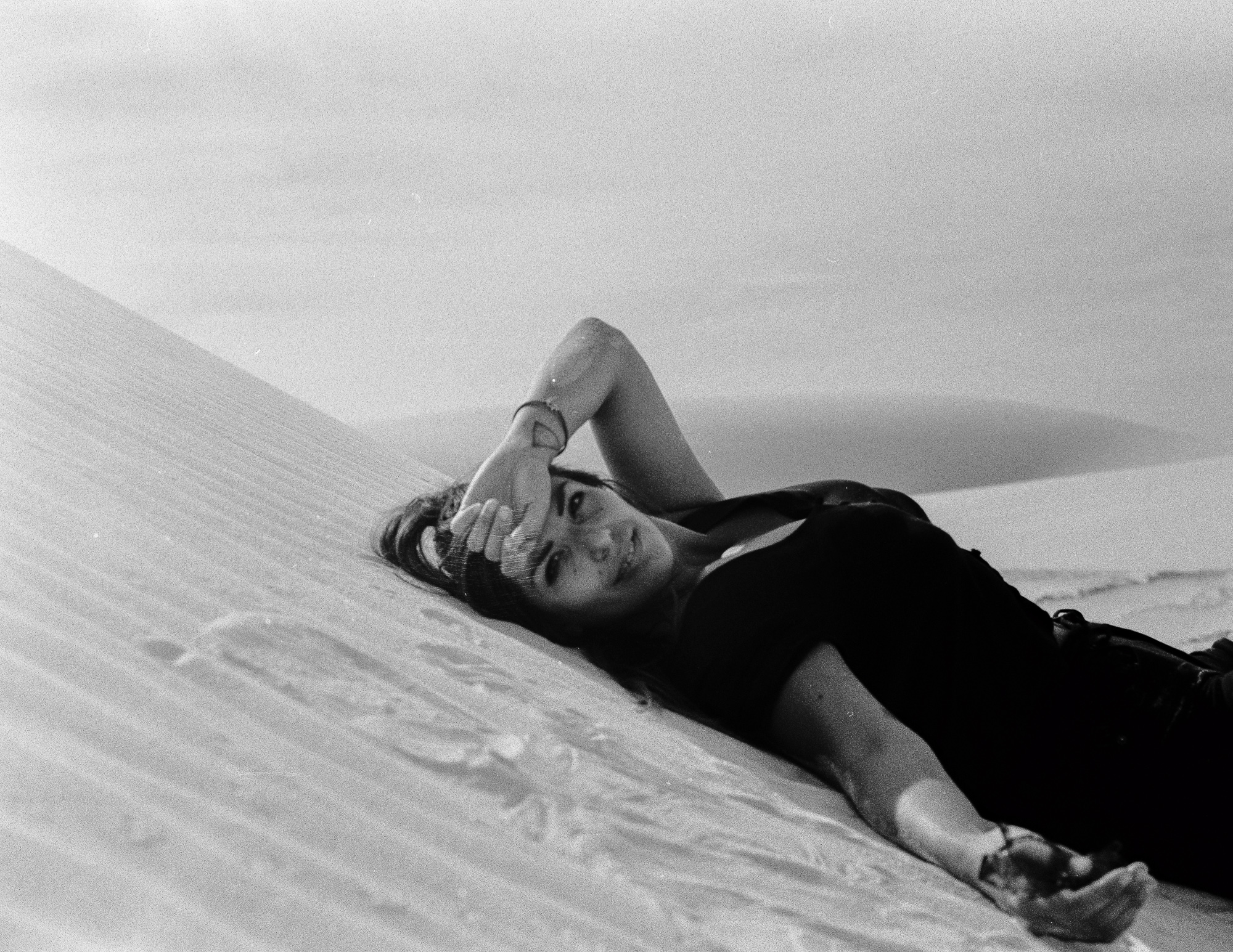 Woman reclining on White Sands dune, 35mm film