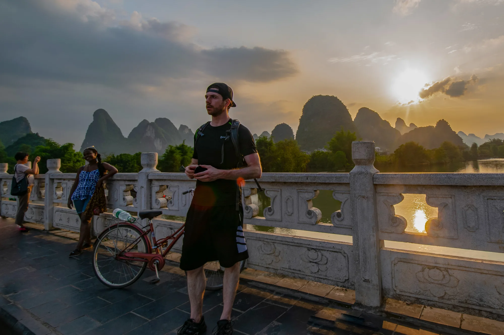 Sunset on Yulong Bridge with Karst peaks, Yangshuo China — closing stillness